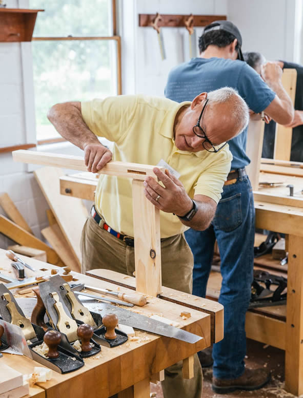 Veteran craftsmen working inside the North Falmouth woodworking shop